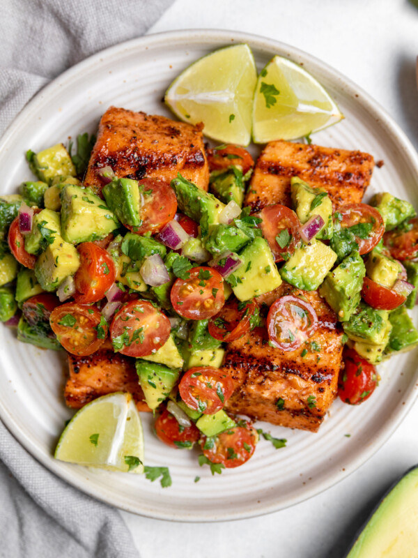 Salmon filets with diced avocado and tomatoes over the top.